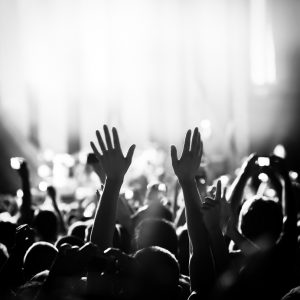 Crowd cheering and watching a band on stage.Click for more concert crowd photos